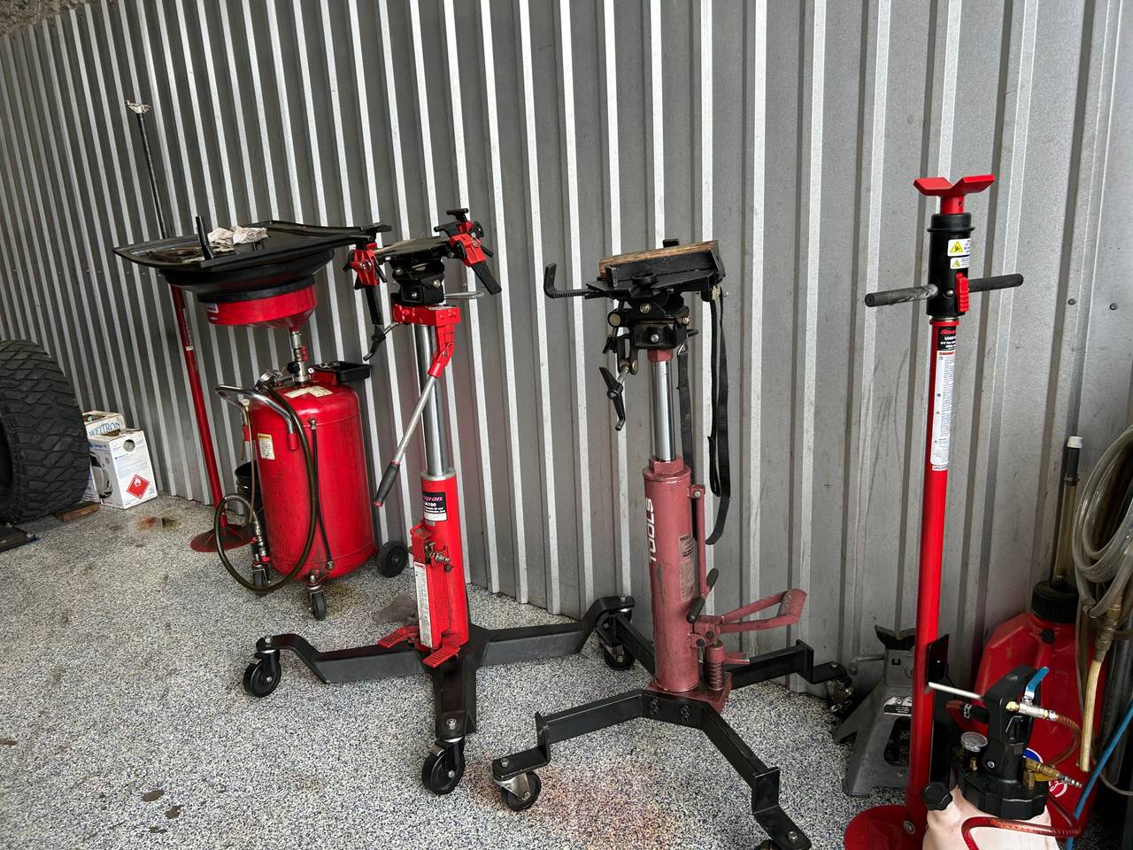 Transmission jacks and fluid service equipment inside the Thomas' Mustang Lube & Auto Repair shop in Kingsland, TX
